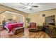 Main bedroom offers good natural lighting, a ceiling fan, a relaxing sitting area, and an ensuite bathroom at 150 Wilbanks St, Buford, GA 30518