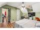 Comfortable bedroom with a ceiling fan, desk, and easy access to the attic at 150 Wilbanks St, Buford, GA 30518