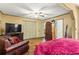 Relaxing main bedroom with comfortable seating, hardwood floors, and ample closet space for organized living at 150 Wilbanks St, Buford, GA 30518