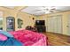 Spacious bedroom with a ceiling fan, flat screen tv, and ample closet space at 150 Wilbanks St, Buford, GA 30518