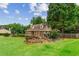 Beautiful front exterior with stone accents, arched windows, and a lush green lawn at 150 Wilbanks St, Buford, GA 30518