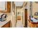 Hallway with view of vanity with wood cabinets and neutral colors offering a simple transition to other rooms at 150 Wilbanks St, Buford, GA 30518