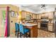 Traditional eat-in kitchen with custom cabinets, updated appliances, and a cozy breakfast bar for casual dining at 150 Wilbanks St, Buford, GA 30518