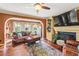 Comfortable living room featuring a fireplace, large windows, and hardwood floors at 150 Wilbanks St, Buford, GA 30518