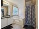 Bright bathroom featuring tub, shower with curtain and vanity with dark countertop at 1592 Smithson Ct, Lithonia, GA 30058