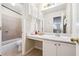 Bathroom featuring a vanity, mirrors, and a bathtub with shower at 1592 Smithson Ct, Lithonia, GA 30058