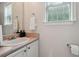 Neutral-colored bathroom featuring vanity and mirror at 1592 Smithson Ct, Lithonia, GA 30058