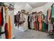 Walk-in closet featuring carpet and many levels of shelving and hanging racks at 1592 Smithson Ct, Lithonia, GA 30058