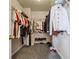 Walk-in closet with carpet and wire shelving filled with clothes and shoes at 1592 Smithson Ct, Lithonia, GA 30058