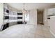 Dining room with tile floors has adjacent kitchen and access to other living spaces at 1592 Smithson Ct, Lithonia, GA 30058