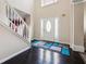 Welcoming foyer featuring a staircase, elegant front door with sidelights, and sleek hardwood floors at 1592 Smithson Ct, Lithonia, GA 30058