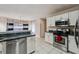 Well-equipped kitchen with stainless steel appliances, white cabinetry, and a practical layout for cooking at 1592 Smithson Ct, Lithonia, GA 30058