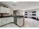 Bright kitchen features white cabinets, stainless steel appliances, and granite countertops at 1592 Smithson Ct, Lithonia, GA 30058