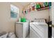 Laundry room featuring washer, dryer and shelving at 1592 Smithson Ct, Lithonia, GA 30058