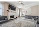 Open living room showcases a fireplace, plush carpeting, custom sofa and a ceiling fan at 1592 Smithson Ct, Lithonia, GA 30058