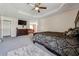 Spacious main bedroom with a trey ceiling, ceiling fan, and neutral carpeting at 1592 Smithson Ct, Lithonia, GA 30058
