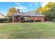 Green backyard with mature trees and a patio at 248 Montrose Dr, Mcdonough, GA 30253