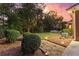 Lush backyard featuring manicured lawn, mature landscaping, and a stone walkway at 248 Montrose Dr, Mcdonough, GA 30253
