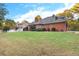 Expansive backyard view of the brick home, showcasing the lawn and mature landscaping at 248 Montrose Dr, Mcdonough, GA 30253