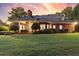 Spacious backyard with a well-kept lawn and inviting brick home with an elegant covered porch at 248 Montrose Dr, Mcdonough, GA 30253