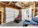 This basement space features a garage door, chair, and exposed ductwork at 248 Montrose Dr, Mcdonough, GA 30253