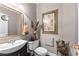 Elegant powder room with decorative accents, a framed mirror, and a stylish vanity sink at 248 Montrose Dr, Mcdonough, GA 30253