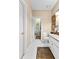 Bathroom with double sinks, framed artwork, animal print rug, and view of exterior at 248 Montrose Dr, Mcdonough, GA 30253