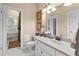 Bathroom with white cabinetry, patterned floor mat, and views of an adjacent room at 248 Montrose Dr, Mcdonough, GA 30253