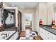 Elegant bathroom featuring a tub, glass shower, black and white floors, and double vanities at 248 Montrose Dr, Mcdonough, GA 30253