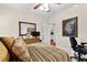Well-lit bedroom features a dresser, mirror, ceiling fan, and doorway to another room at 248 Montrose Dr, Mcdonough, GA 30253