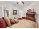Comfortable bedroom featuring a ceiling fan, and large wooden dresser with decor at 248 Montrose Dr, Mcdonough, GA 30253