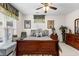 The Primary bedroom includes a ceiling fan, neutral decor, and plenty of natural light at 248 Montrose Dr, Mcdonough, GA 30253