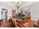 Elegant dining space with a large wooden table, ornate centerpieces, and views into the living areas at 248 Montrose Dr, Mcdonough, GA 30253