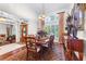 Dining room showcasing hardwood floors, a large window with shutters, and ornate dining set at 248 Montrose Dr, Mcdonough, GA 30253
