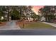 Charming brick home featuring a lush front lawn and inviting driveway under a colorful sunset sky at 248 Montrose Dr, Mcdonough, GA 30253
