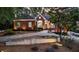 Inviting brick home with manicured shrubs, stone accents, and warm exterior lighting at 248 Montrose Dr, Mcdonough, GA 30253