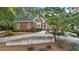 Beautiful brick home featuring a manicured lawn, lush landscaping, and an elegant driveway at 248 Montrose Dr, Mcdonough, GA 30253