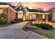 Charming brick home with meticulously landscaped front yard and inviting entrance at twilight at 248 Montrose Dr, Mcdonough, GA 30253