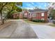 Beautiful brick home with a well-kept lawn, concrete driveway, and mature trees for shade at 248 Montrose Dr, Mcdonough, GA 30253