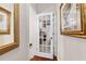 Hallway with wood floors and white walls featuring decorative hanging art at 248 Montrose Dr, Mcdonough, GA 30253