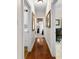 Hallway with hardwood floors leads to multiple rooms including a laundry room and office at 248 Montrose Dr, Mcdonough, GA 30253