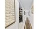 Hallway with unique wall decor and a patterned runner leading to a cozy room at 248 Montrose Dr, Mcdonough, GA 30253