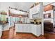 Open kitchen with white cabinets, granite countertops, bay window, and breakfast area at 248 Montrose Dr, Mcdonough, GA 30253