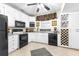 Well-lit kitchen features white cabinets and modern black appliances at 248 Montrose Dr, Mcdonough, GA 30253