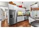Bright kitchen features stainless appliances, white cabinetry, granite counters, and hardwood floors at 248 Montrose Dr, Mcdonough, GA 30253