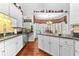 Well-designed kitchen with white cabinets, granite countertops, and a view to the dining nook at 248 Montrose Dr, Mcdonough, GA 30253