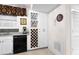Corner kitchen with black appliances, wine wrack, and white cabinets at 248 Montrose Dr, Mcdonough, GA 30253
