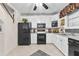 Bright kitchen features black appliances, white cabinets, and grey countertops at 248 Montrose Dr, Mcdonough, GA 30253