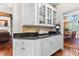 Bright kitchen with white cabinetry, black countertops, and seamless access to the dining area at 248 Montrose Dr, Mcdonough, GA 30253