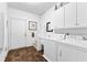 Bright laundry room with white appliances, tile floor and ample storage at 248 Montrose Dr, Mcdonough, GA 30253